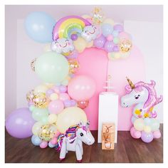 a unicorn themed birthday party with balloons and decorations