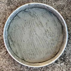 a dirty bowl is sitting on the ground