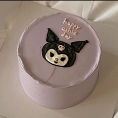 a birthday cake decorated with a bat and skull