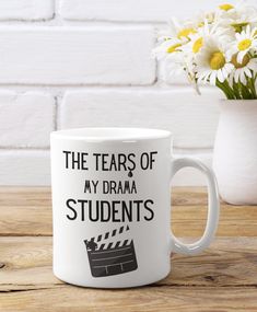 the tears of my drama students coffee mug on a table with daisies in a vase