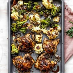 chicken, broccoli and cauliflower in a baking pan on a table