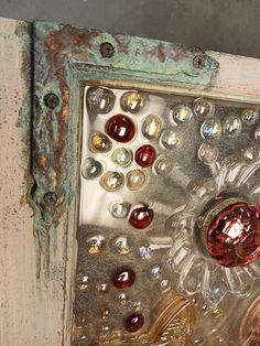 an old window with some glass beads on it