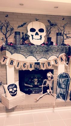 a fireplace decorated for halloween with skeleton decorations