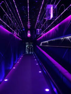 the inside of a tunnel with purple lights