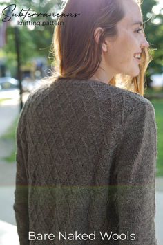 a woman wearing a brown sweater standing in front of a tree with the words bare naked wools on it