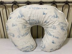 the pillow is shaped like a boat in the water and has blue ink on it