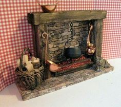 a miniature fireplace with pots and pans on it