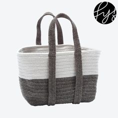 a gray and white basket with handles hanging from it