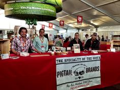 three men sitting at a table in front of a sign that says the specialty of the south