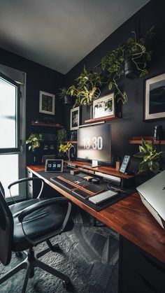 a desk with a computer and some plants on it