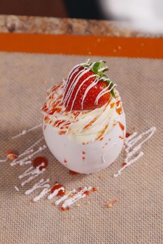 a dessert with strawberries and whipped cream on the top is ready to be eaten