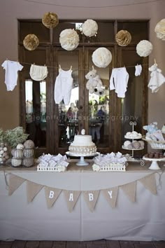 a baby shower party with white and gold decorations