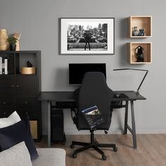 a black chair sitting in front of a computer desk