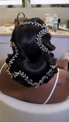 a woman is sitting in a bathtub wearing a headpiece with leaves on it