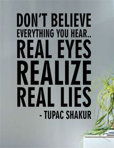 a black and white wall decal with the words don't believe everything you hear real