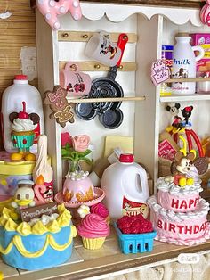 a doll house with lots of toys on the shelf