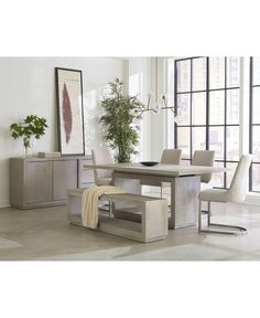 a dining room table and chairs in front of a large window with potted plants