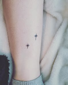 a woman's foot with small stars on her left leg and the word love is written in black ink