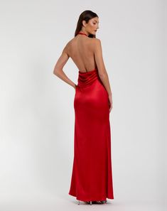 a woman in a red dress with her back to the camera