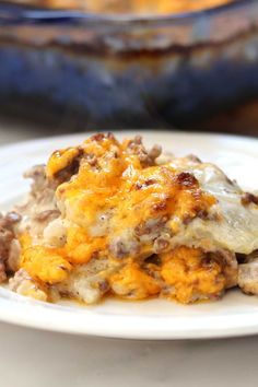 a close up of a plate of food on a table with a casserole dish in the background