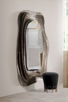 a mirror sitting on top of a table next to a chair