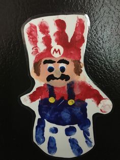 a handprinted image of a man wearing a red hat and blue overalls