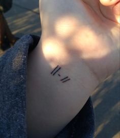 a person with a tattoo on their wrist