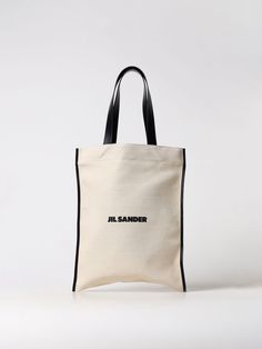 Find JIL SANDER Tote Bags on Editorialist. This Jil Sander tote bag is crafted from canvas and features a top handle. It has a logo detail. The bag can be worn on the shoulder or carried in the hand. White Tote Bag, White Tote, Italian Fashion Designers, Jil Sander, A Logo, White Bag, Italian Fashion, Woman Colour, Sanders