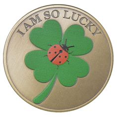 a gold coin with a ladybug on the front and i am so lucky written on it