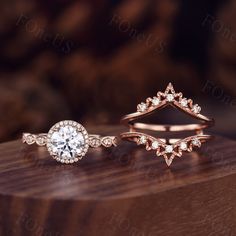 three different types of wedding rings on top of a wooden table