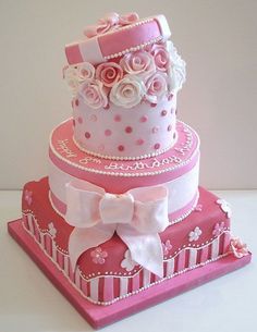 three tiered cake with pink and white decorations