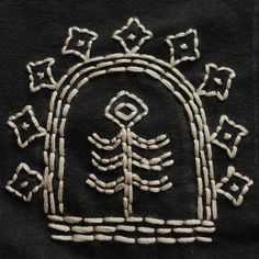 an embroidered design on a black shirt with white thread