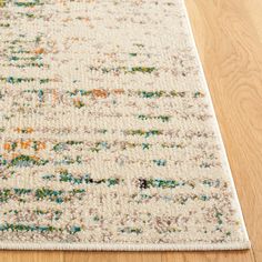 a white rug with multicolored designs on it