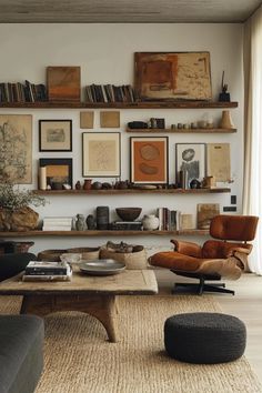 a living room filled with furniture and pictures on the wall