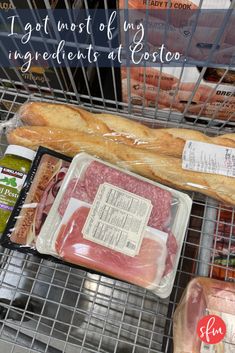 an assortment of meats and bread in a grocery cart