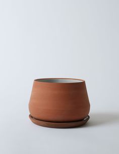 a clay bowl sitting on top of a white table