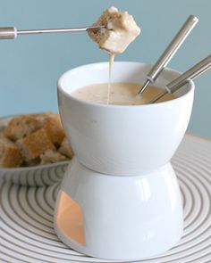 a white cup filled with liquid sitting on top of a table