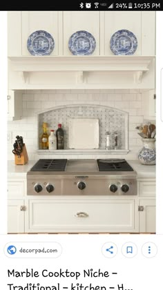 a white kitchen with blue and white plates above the stove