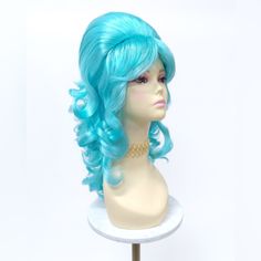 Bring Back The Swingin' 60's With This Awesome Psychedelic Beehive Wig! Synthetic. Some Styling May Be Required. *Not Heat Resistant, Do Not Use Heating Tools. Color: Blue Length: 17" Inches Circumference: Adjustable 21" - 22" Inches Materials: Synthetic Fibers Brand New Item Turquoise Wig, 60s Beehive, Beehive Wig, Beige Blonde Balayage, Blue Wigs, Bohemian Hair Accessories, Blue Bob, Glow Hair, Small Hair Clips