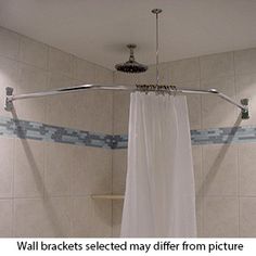 the shower curtain is open in this bathroom with white tile walls and floor tiles on the wall