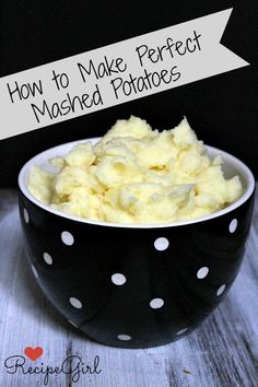 a bowl filled with mashed potatoes sitting on top of a wooden table next to a black and white polka dot bowl