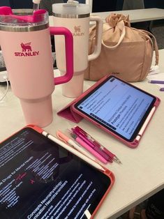 the tablet is next to a pink coffee mug