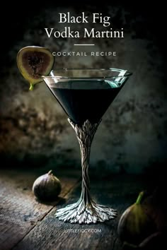 the black fig vodka martini cocktail is served in a coupe glass with an olive slice