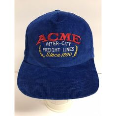 a blue acme hat sitting on top of a white table