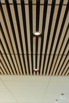 the ceiling is covered with wooden slats