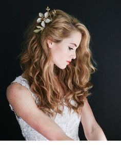 a woman wearing a white dress and holding a knife in her hand with flowers on it