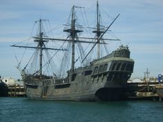 an old pirate ship is docked in the water