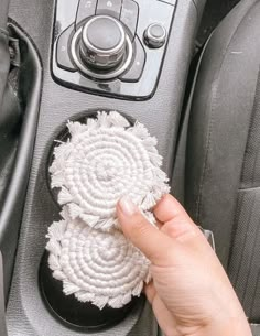 a person is cleaning the inside of a car with a rag and a cloth brush