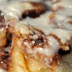 a close up of a cinnamon roll with icing