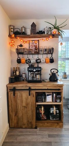 the coffee bar is decorated with hanging lights and potted plants on shelves above it